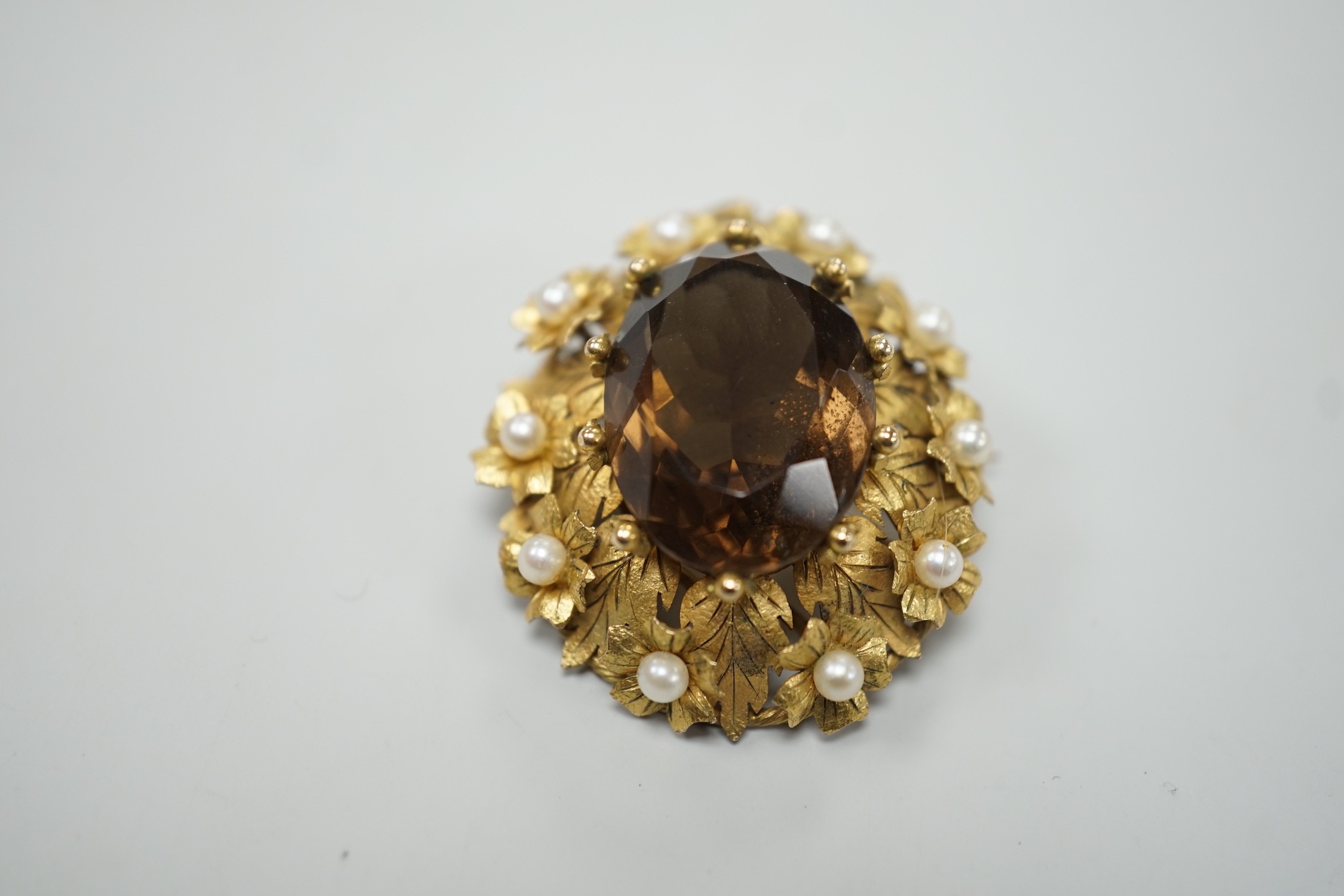 A yellow metal, oval cut brown quartz and cultured pearl set pendant brooch, 34mm, gross weight 12.8 grams.
